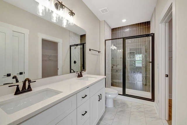 bathroom featuring vanity, an enclosed shower, and toilet