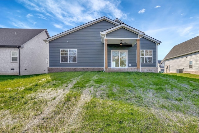 back of property featuring central AC, ceiling fan, and a lawn