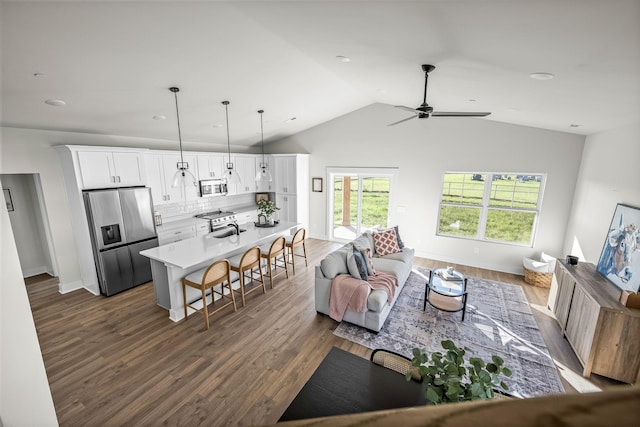 living room with lofted ceiling, sink, dark hardwood / wood-style floors, and ceiling fan