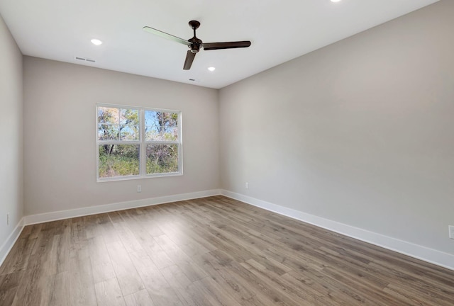 spare room featuring ceiling fan and light hardwood / wood-style flooring