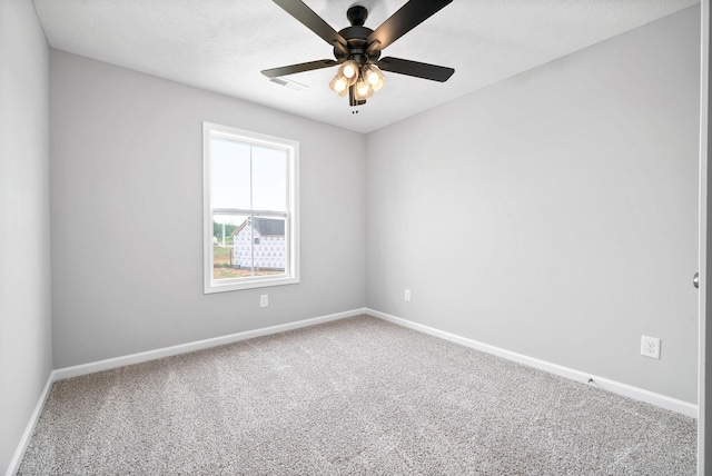 carpeted empty room with a textured ceiling and ceiling fan