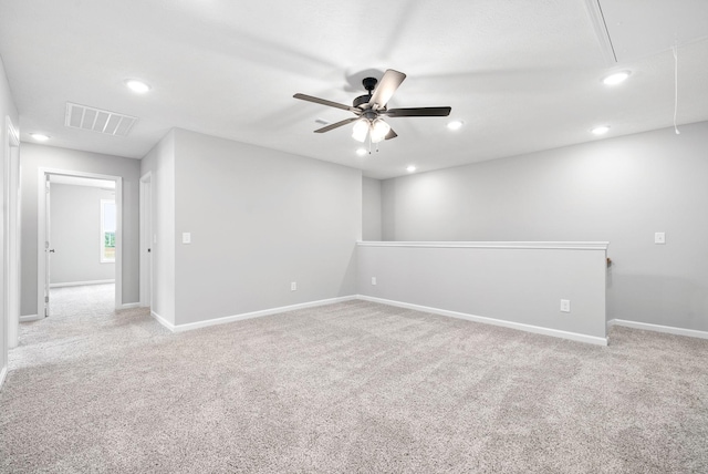 carpeted spare room with ceiling fan