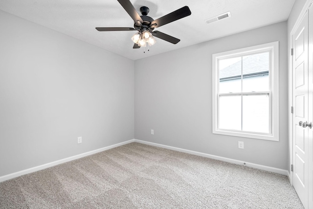 carpeted spare room featuring ceiling fan