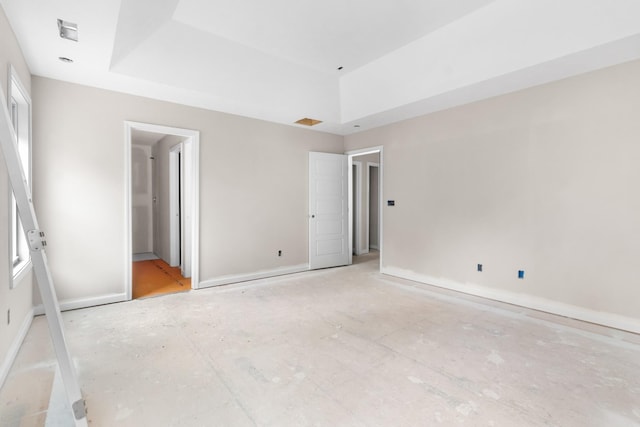 unfurnished bedroom featuring a raised ceiling