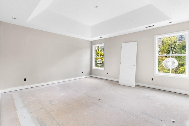 unfurnished bedroom with a raised ceiling