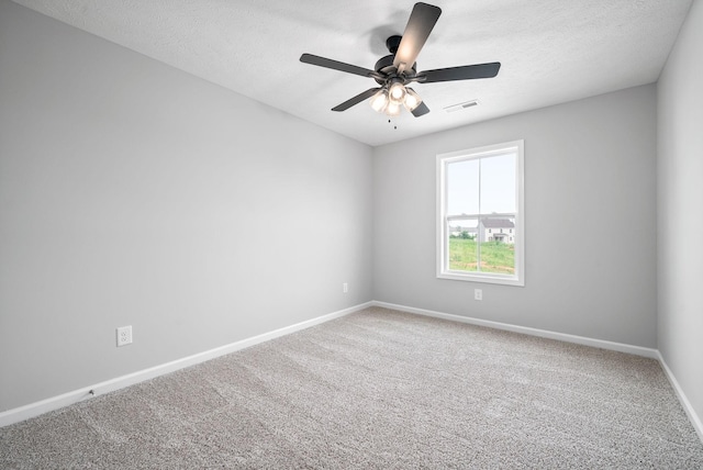 unfurnished room with ceiling fan, carpet, and a textured ceiling