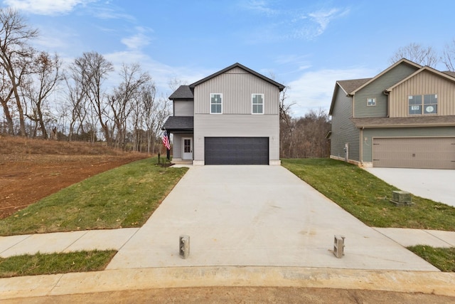 view of front of property with a garage and a front lawn