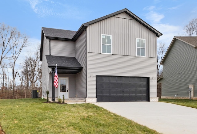 view of front of property with central AC, a garage, and a front yard