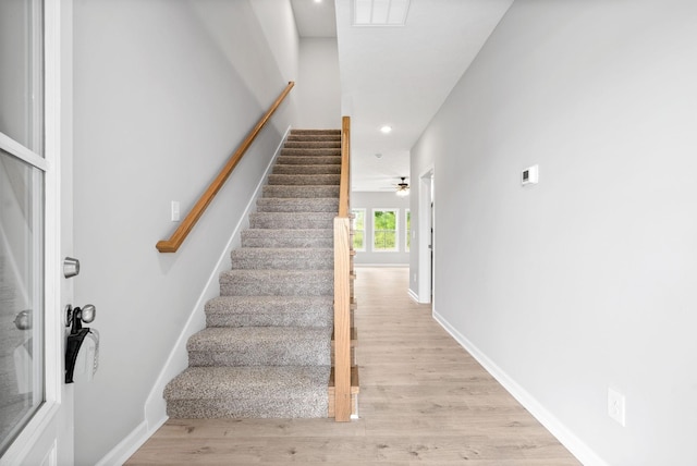 stairway featuring hardwood / wood-style flooring