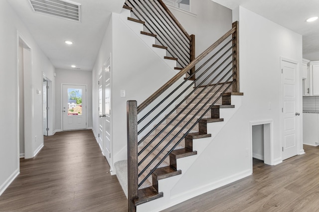 staircase with hardwood / wood-style flooring