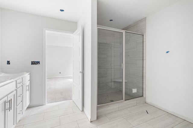 bathroom with vanity, tile patterned flooring, and a shower with door