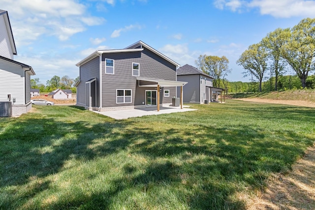 back of property featuring a yard, central AC, and a patio