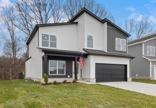 view of front of property featuring cooling unit, a garage, and a front yard