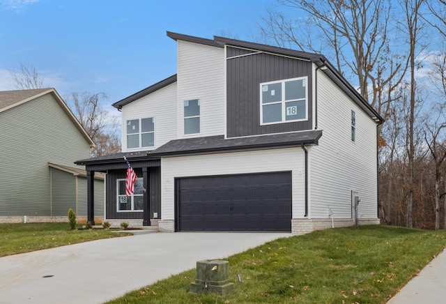 contemporary house featuring a garage and a front yard