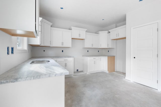 kitchen featuring white cabinetry and sink