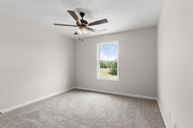 carpeted spare room featuring ceiling fan and a textured ceiling