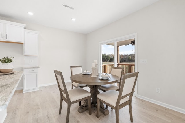 dining space with light hardwood / wood-style floors