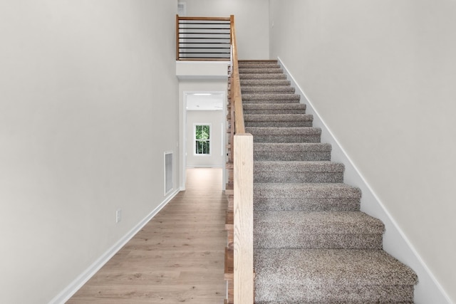 staircase featuring wood-type flooring