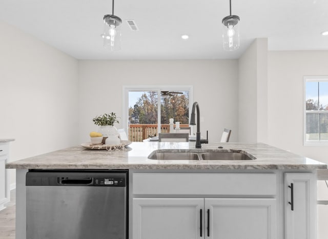 kitchen featuring stainless steel dishwasher, decorative light fixtures, sink, and white cabinets