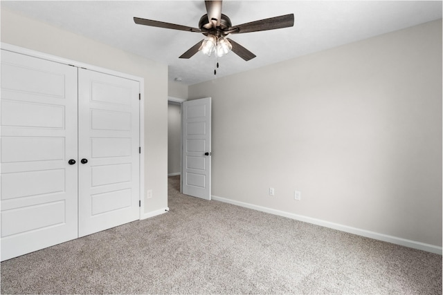 unfurnished bedroom featuring carpet, ceiling fan, and a closet