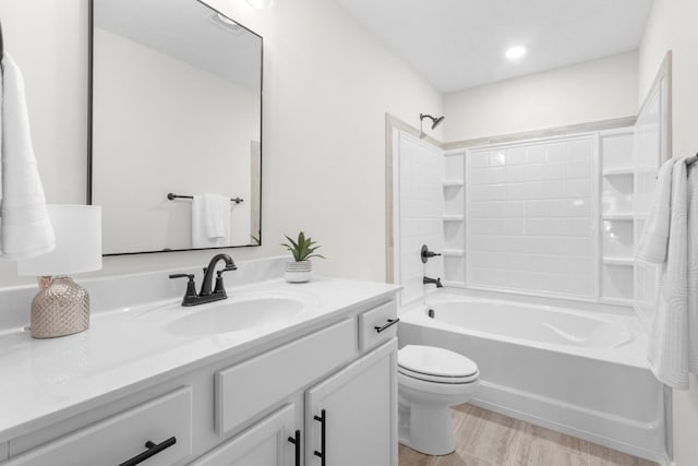 full bathroom featuring toilet, vanity, and bathtub / shower combination