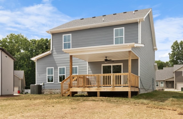 rear view of property with central AC, ceiling fan, a yard, and a deck