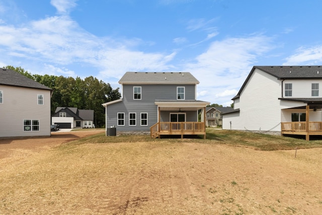 back of house with a wooden deck and ceiling fan