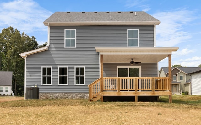 back of house featuring a wooden deck, ceiling fan, a yard, and central air condition unit