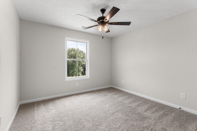 carpeted spare room with a textured ceiling and ceiling fan