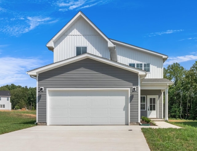 view of front of home with a garage and a front lawn