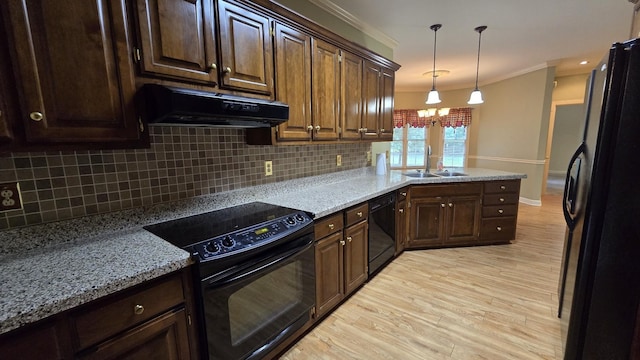 kitchen featuring sink, ornamental molding, pendant lighting, light hardwood / wood-style floors, and black appliances