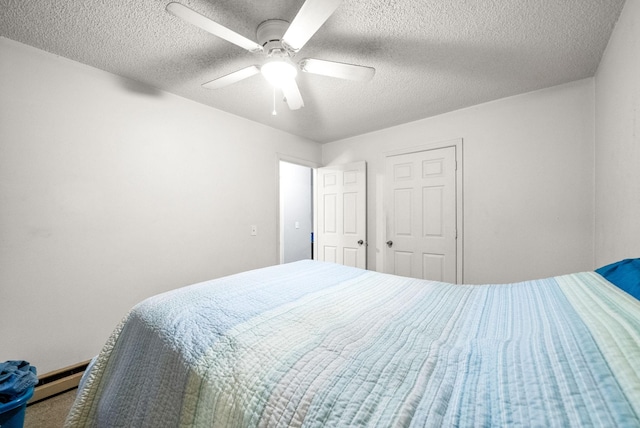 bedroom featuring a textured ceiling, ceiling fan, and baseboard heating