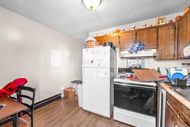 kitchen with white refrigerator, electric range, a textured ceiling, and light hardwood / wood-style flooring