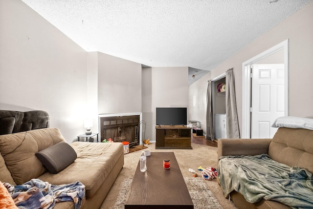 carpeted living room featuring a textured ceiling