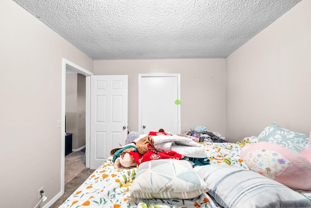 bedroom with carpet floors and a textured ceiling