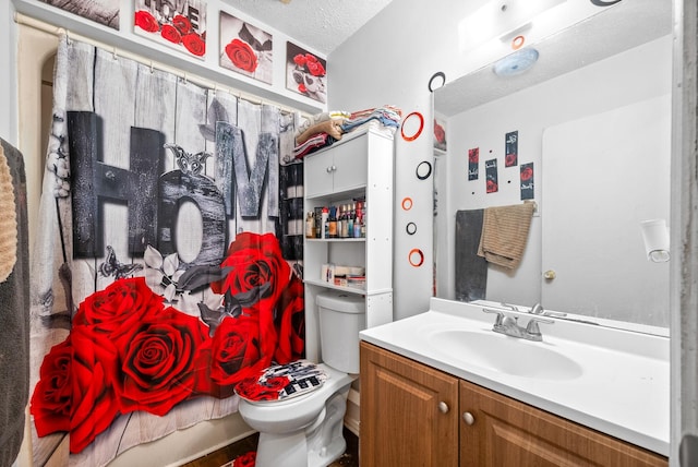 bathroom with vanity, a textured ceiling, and toilet