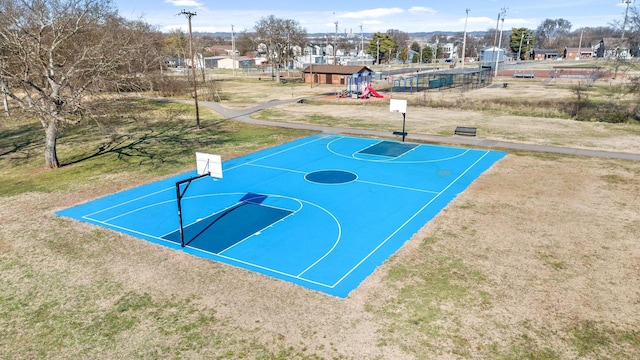 view of sport court featuring a lawn and a playground