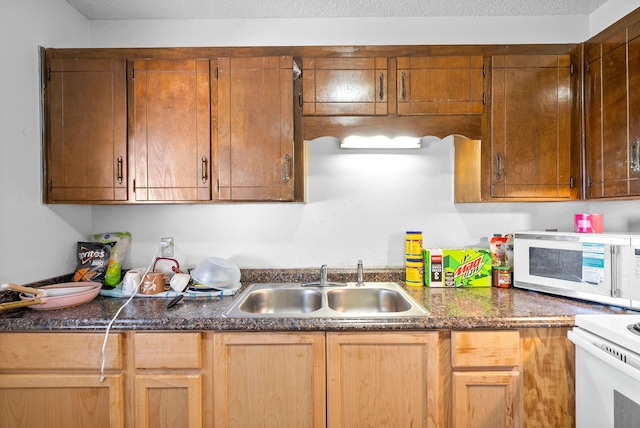 kitchen featuring sink and a textured ceiling