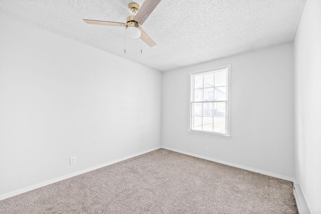 unfurnished room featuring ceiling fan, carpet flooring, and a textured ceiling