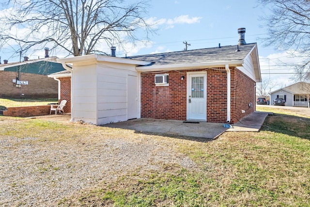 rear view of property featuring a wall mounted air conditioner, a yard, and a patio area