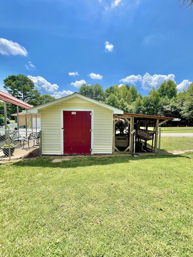 view of outbuilding featuring a yard