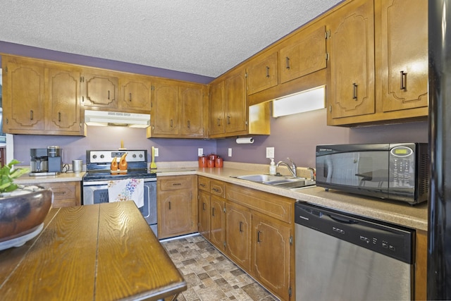 kitchen featuring sink, a textured ceiling, and black appliances