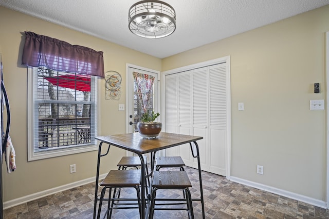 dining space with a textured ceiling