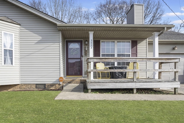 property entrance with covered porch and a lawn