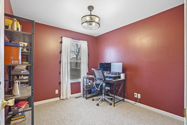 home office with carpet and a textured ceiling