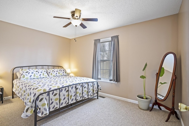 bedroom featuring ceiling fan, a textured ceiling, and carpet