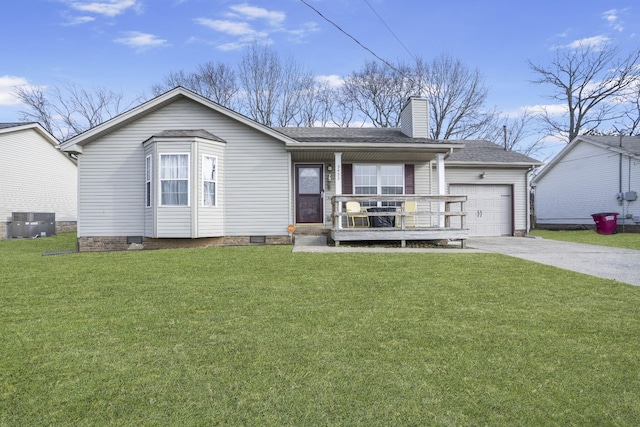 ranch-style home featuring cooling unit, a garage, covered porch, and a front yard