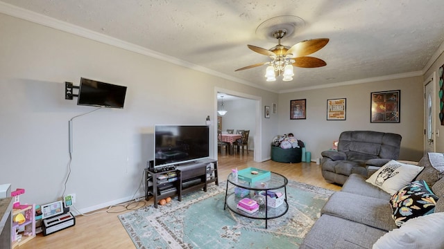 living room with ornamental molding, a textured ceiling, ceiling fan, and light hardwood / wood-style flooring