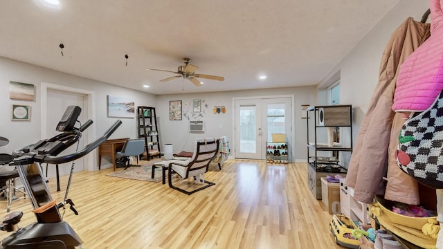 exercise room featuring french doors, ceiling fan, and light wood-type flooring