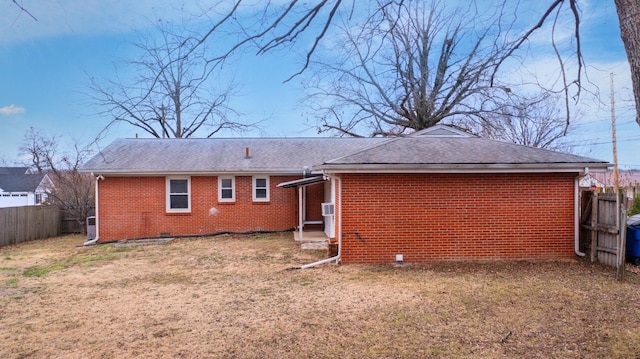 rear view of property featuring a yard